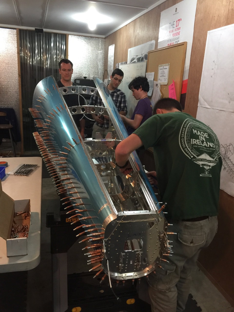 Builders working together on the aluminum aircraft structure in the workshop